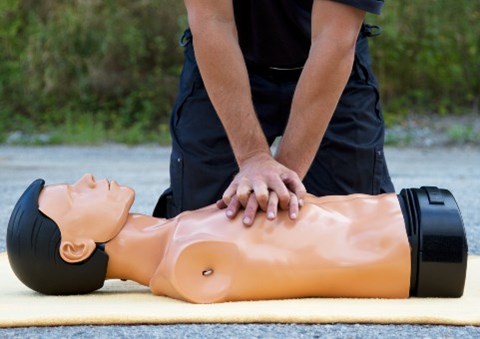 Man giving CPR on a dummy