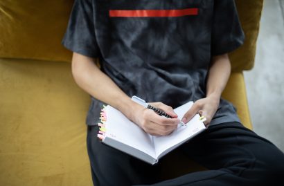 Young person completing a diary