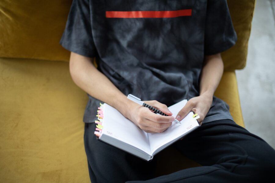 Young person completing a diary