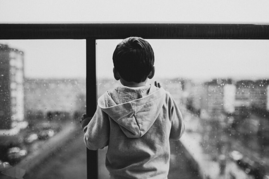 Child behind a window looking out