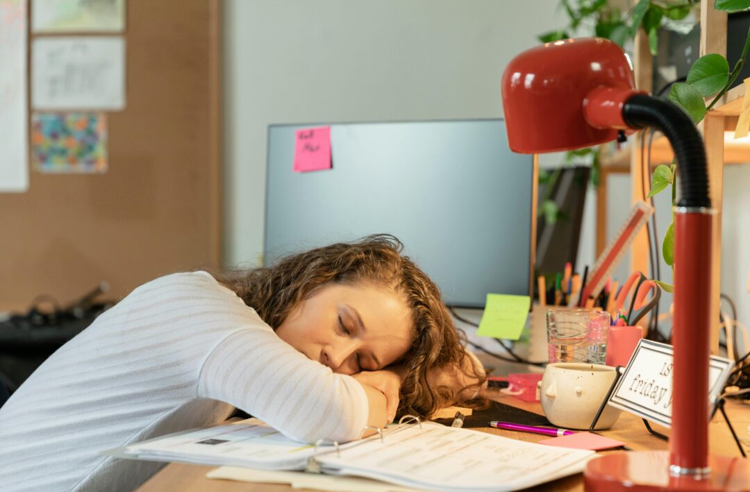 Tired person asleep at desk